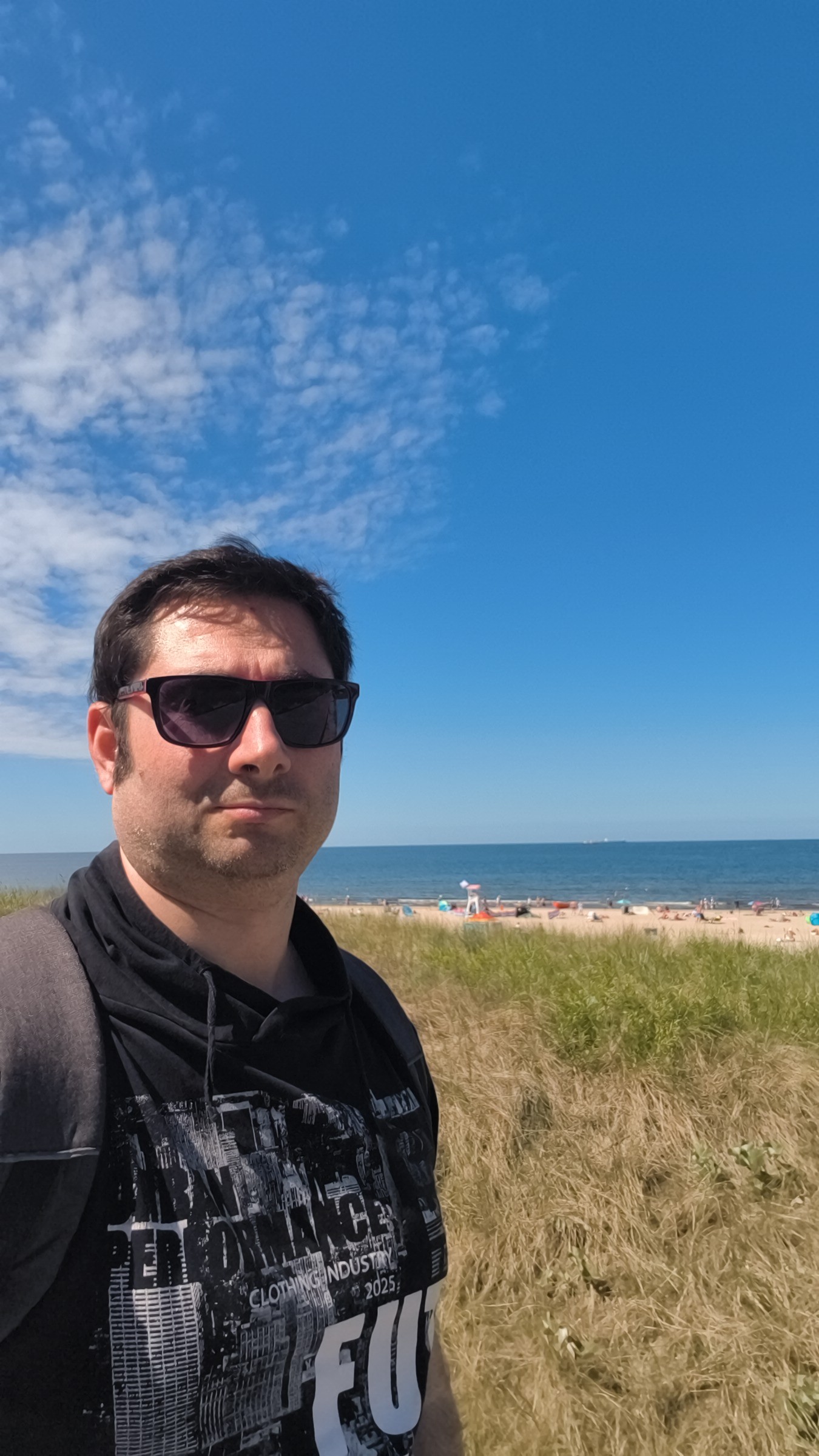 Łukasz Ogorzałek on a Mediterranean beach at golden hour — the light that started everything