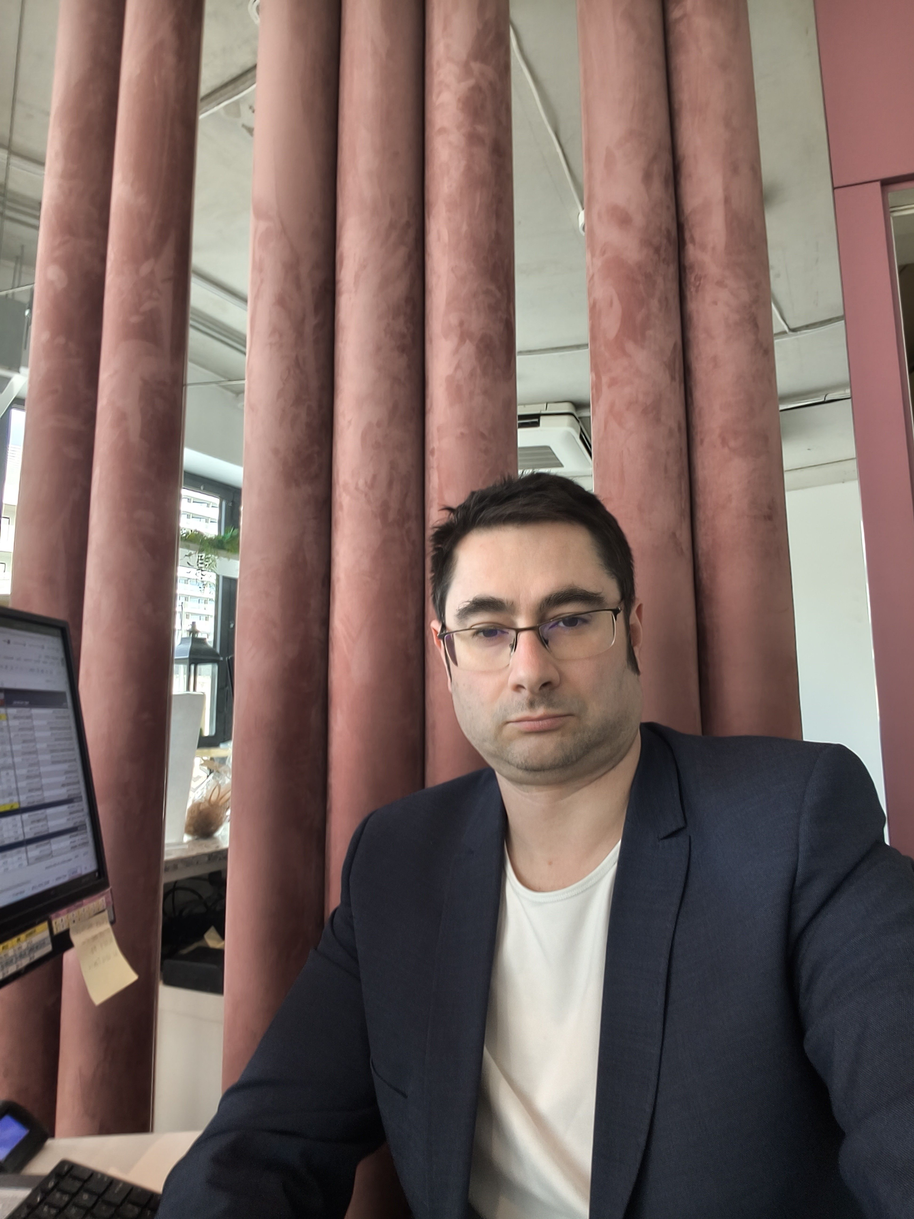 In the studio — navy blazer, pink columns, where Escale Privée is shaped